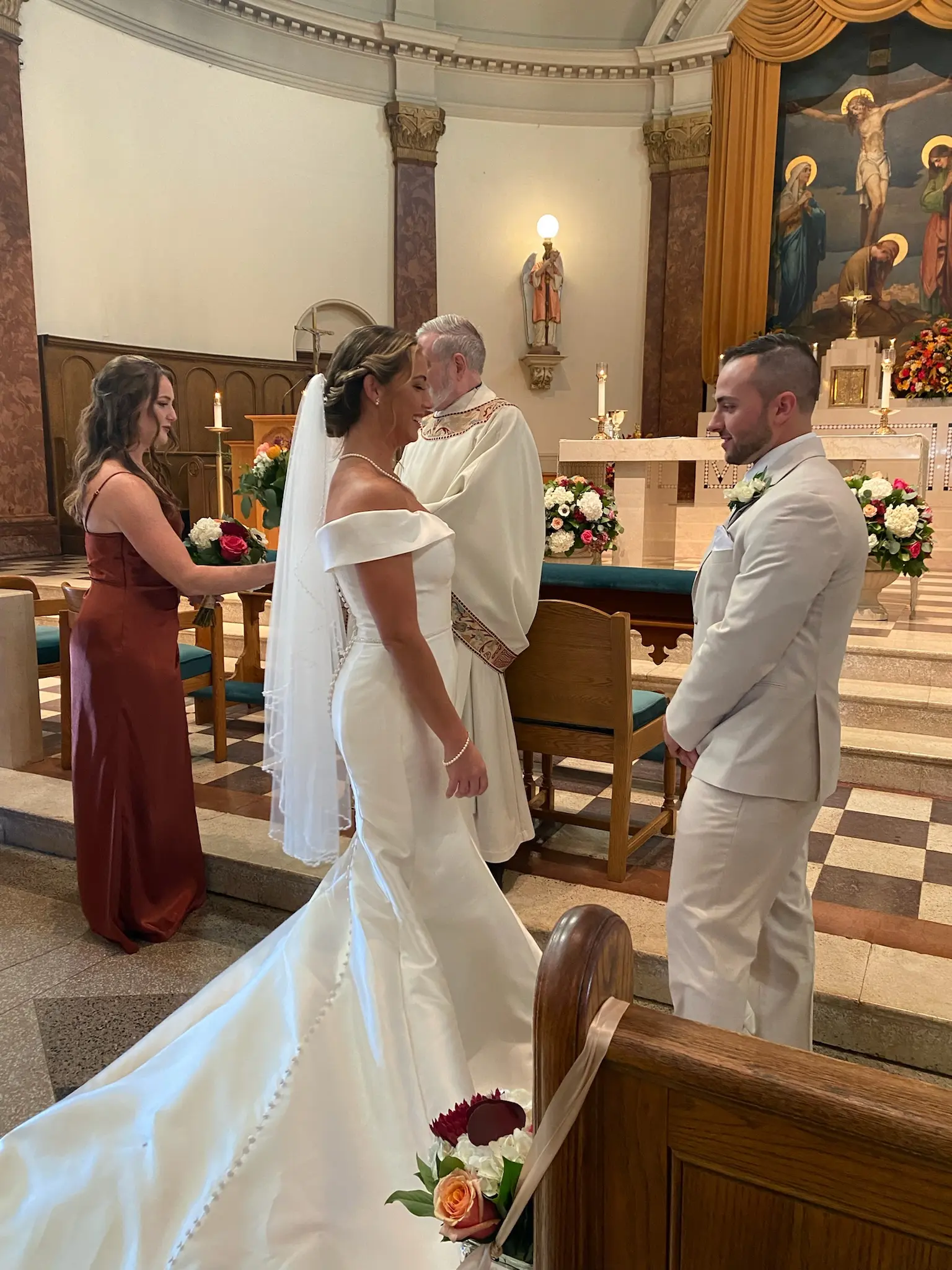 Bride Wearing Simple Fit And Flare Wedding Dress Called Josie By Rebecca Ingram At The Church Ceremony