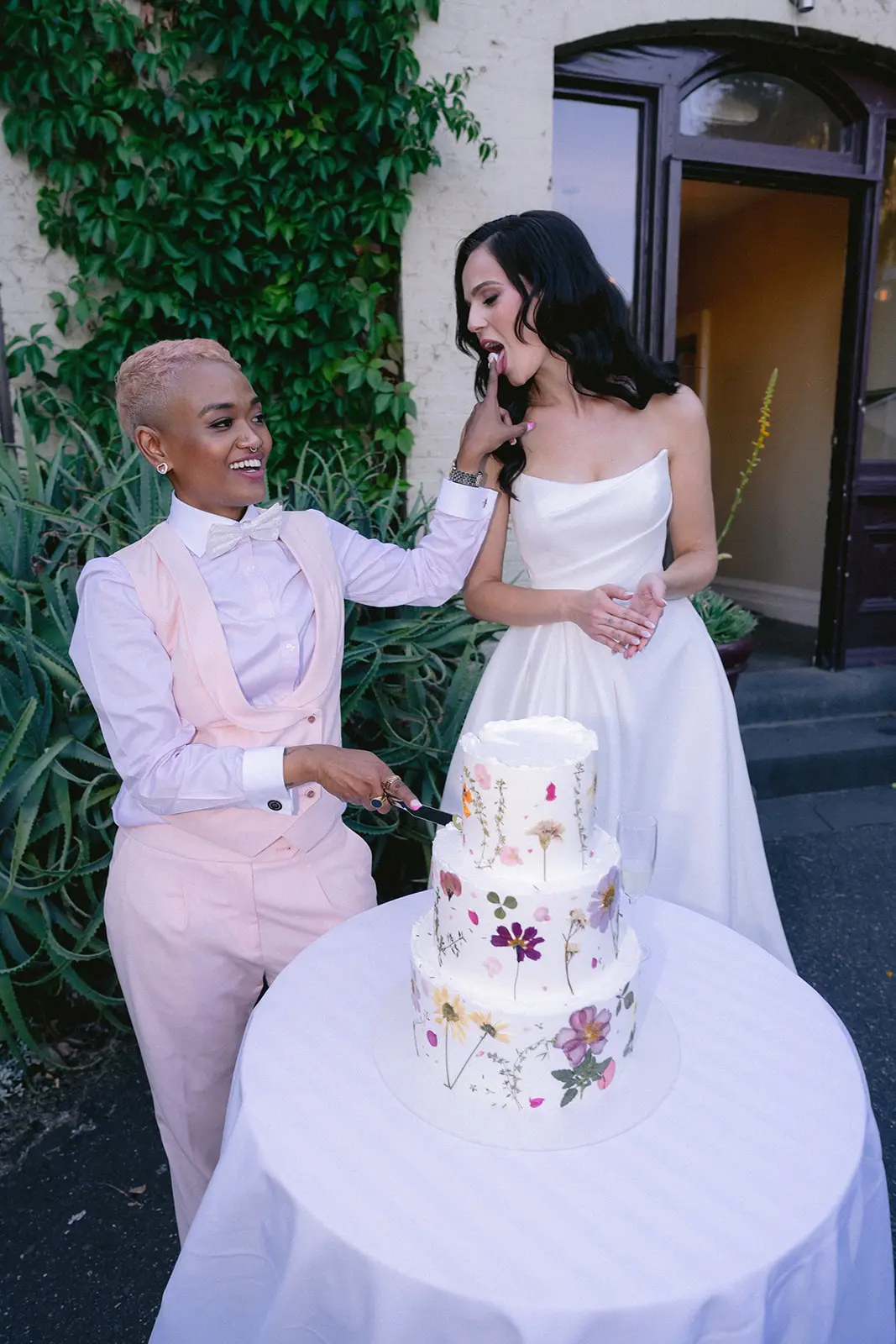 Bride wearing Aspen by Sottero and Midgley cutting the cake with her partner