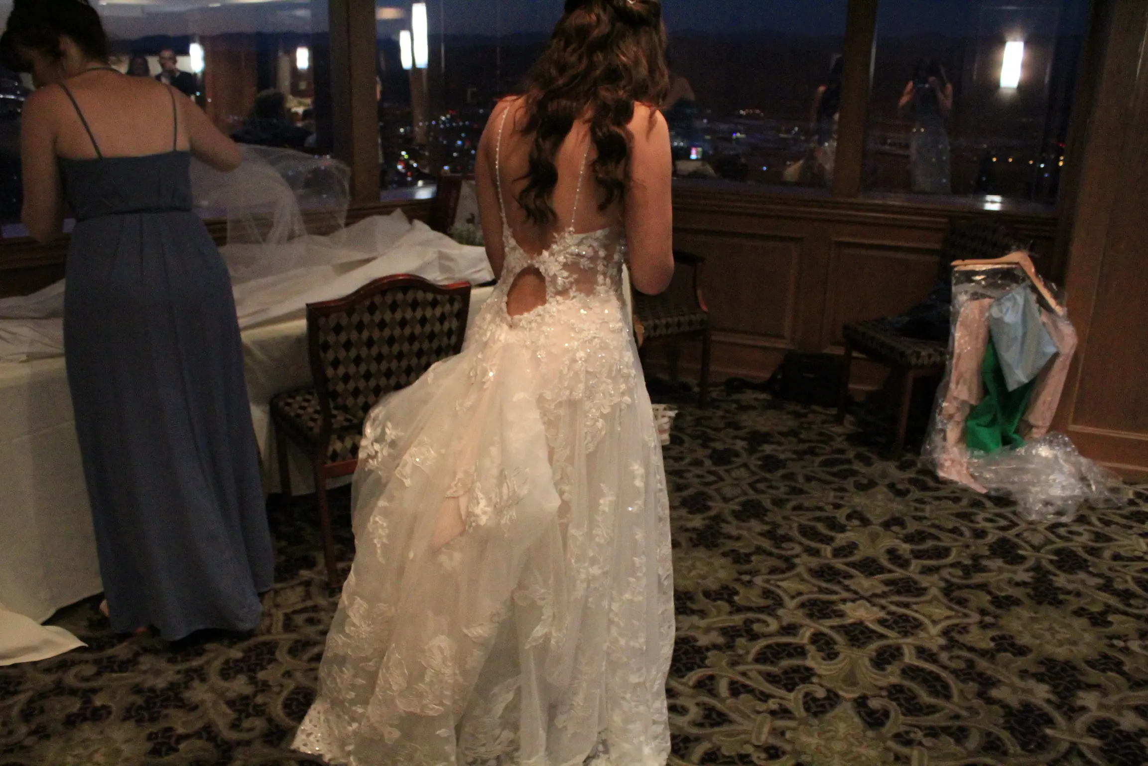 Bride's dress called Marlow with her train bustled for the night party.