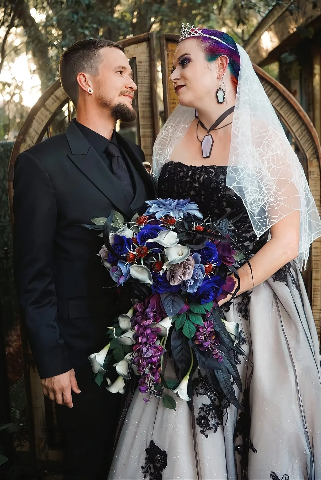 Bride Wearing Black Lace Wedding Dress Called Norvinia By Sottero and Midgley With Groom And A Dark Floral Bouquet