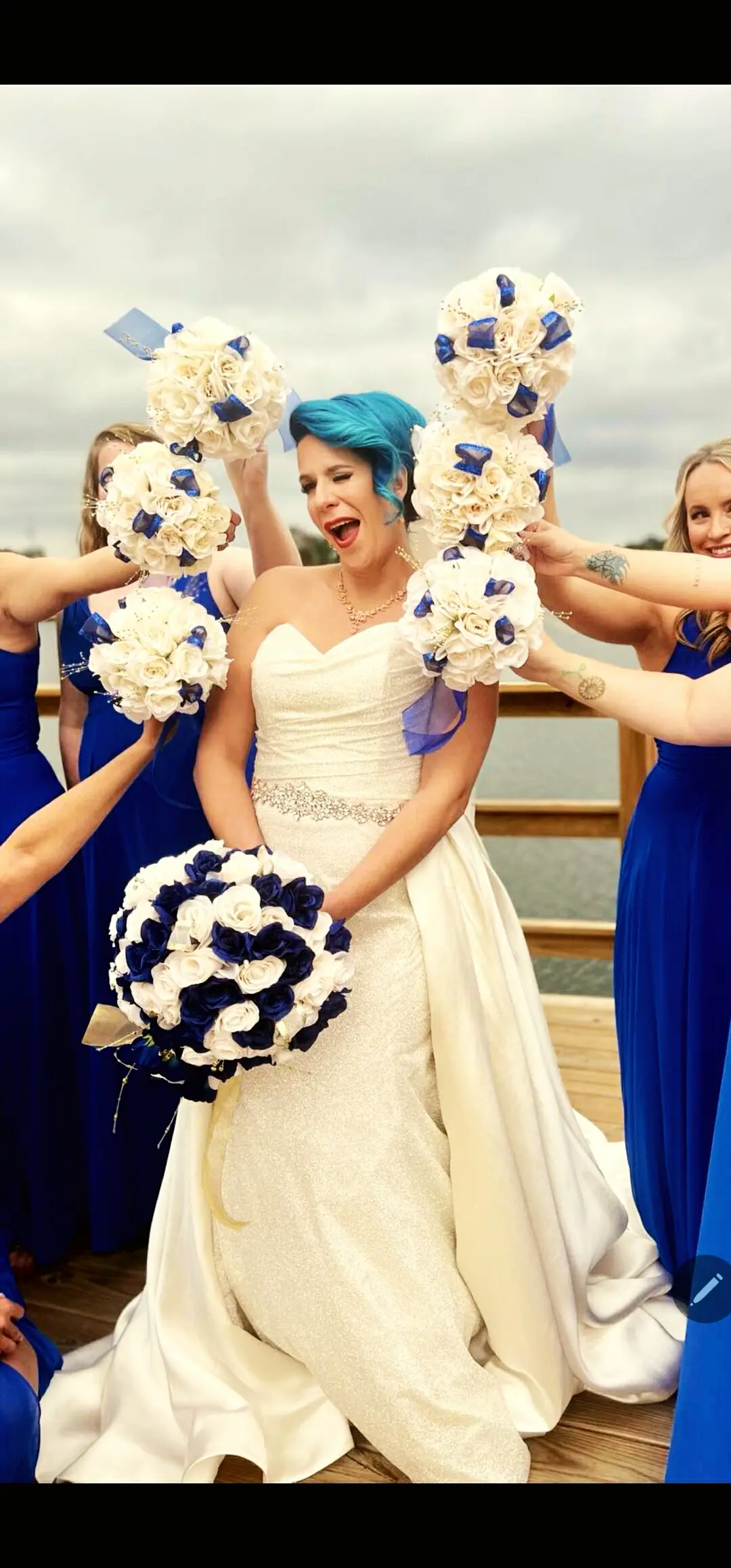 Bride Wearing Sparkly Fit-and-Flare Wedding Dress With Bridesmaids Holding Their Bouquets