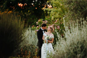 Bride Wearing A-line Classic Wedding Dress Ekaterina By Maggie Sottero With Groom In Foliage