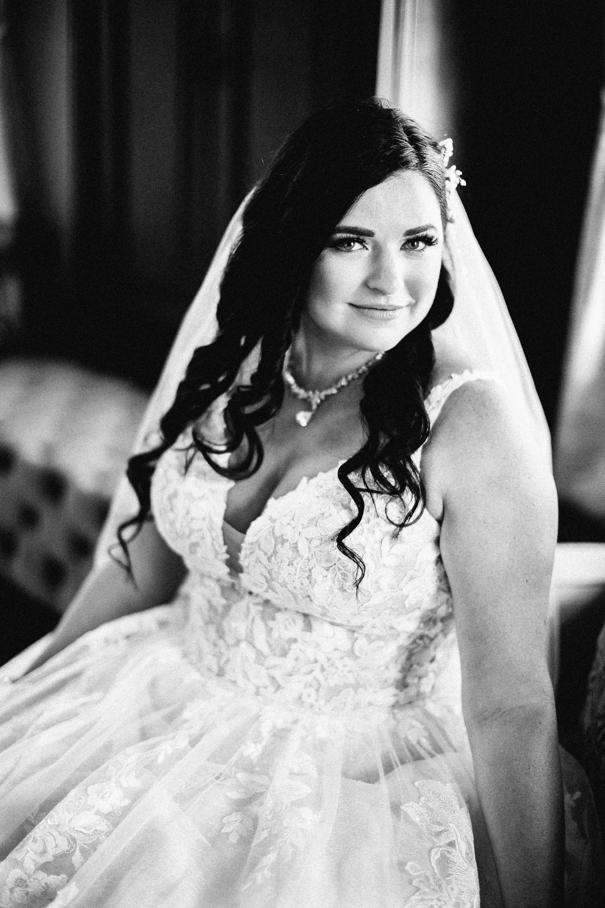 Portrait in black and white of bride wearing wedding dress called Valona.