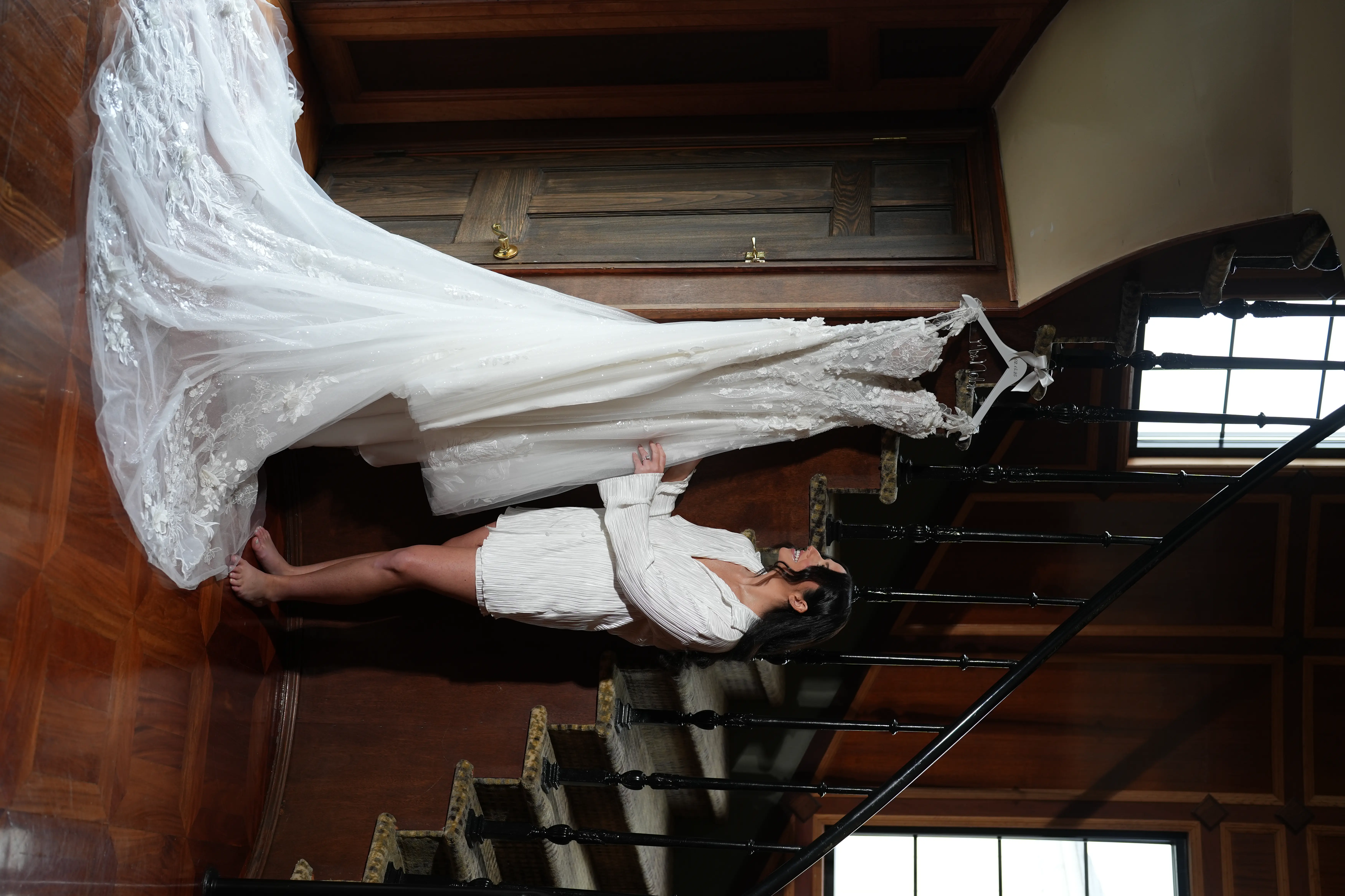 Bride Looking At Her Wicklow Wedding Dress By Sottero And Midgley Hanging On The Stairs