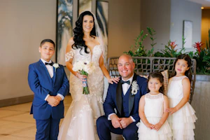 Bride Wearing Lace Mermaid Wedding Gown Called Hattie By Rebecca Ingram With The Groom And Their Family