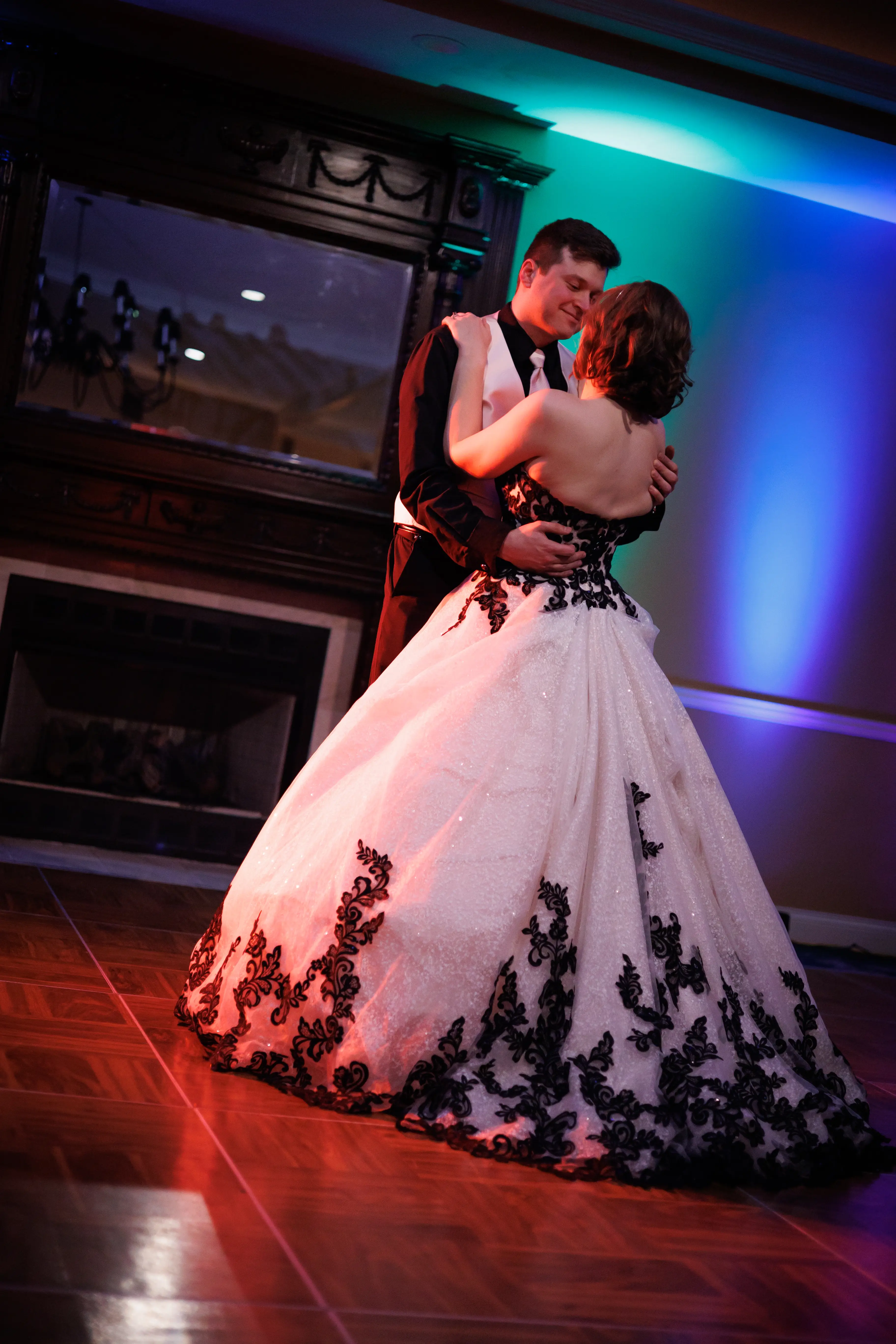 Bride And Groom Dancing Together. Bride Wearing Black And White Lace Strapless Ball Gown Called Tristyn By Maggie Sottero