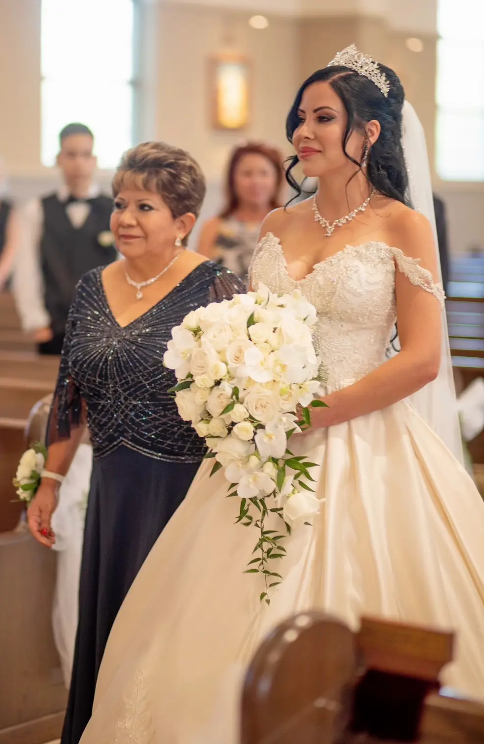 Bride wearing elegant satin ballgown called Kimora by Sottero and Midgley with mother