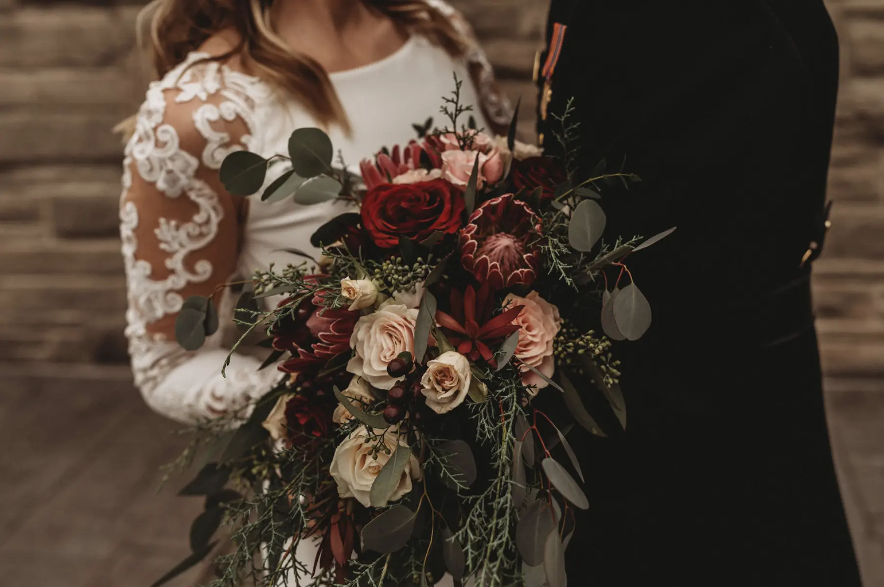 Groom with Bride in Minimalist Crepe Long Sleeve Lace Sheath Wedding Dress Called Bethany by Rebecca Ingram