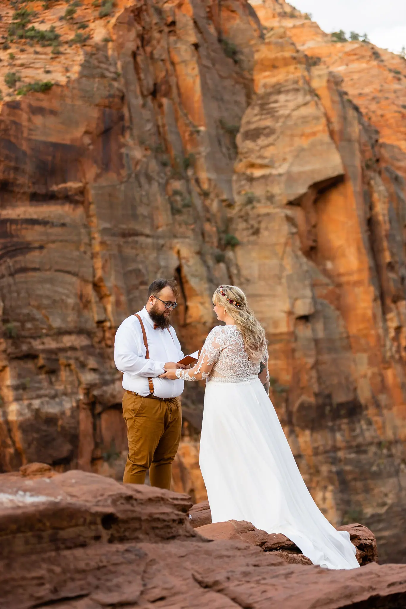 Real Bride in Long Sleeved, Thigh-High Slit Wedding Dress Named Lorraine by Rebecca Ingram with Groom