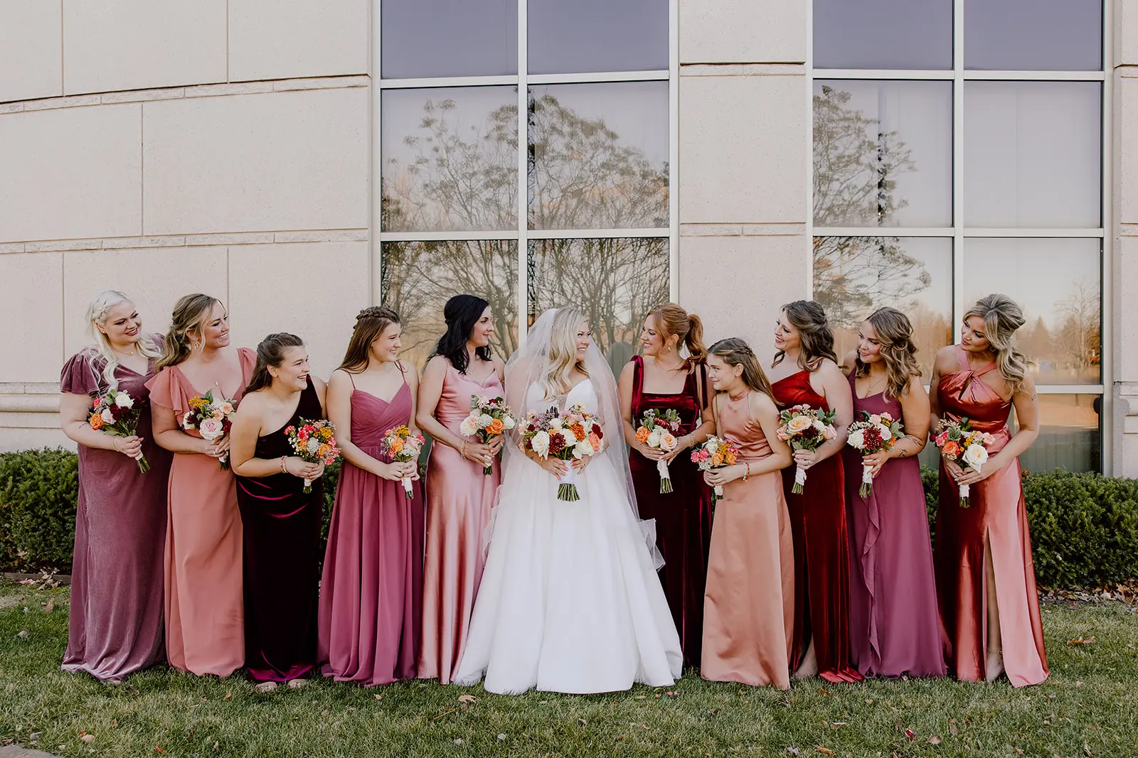 Bride wearing Derrick by Maggie Sottero surrounded by her bridesmaids