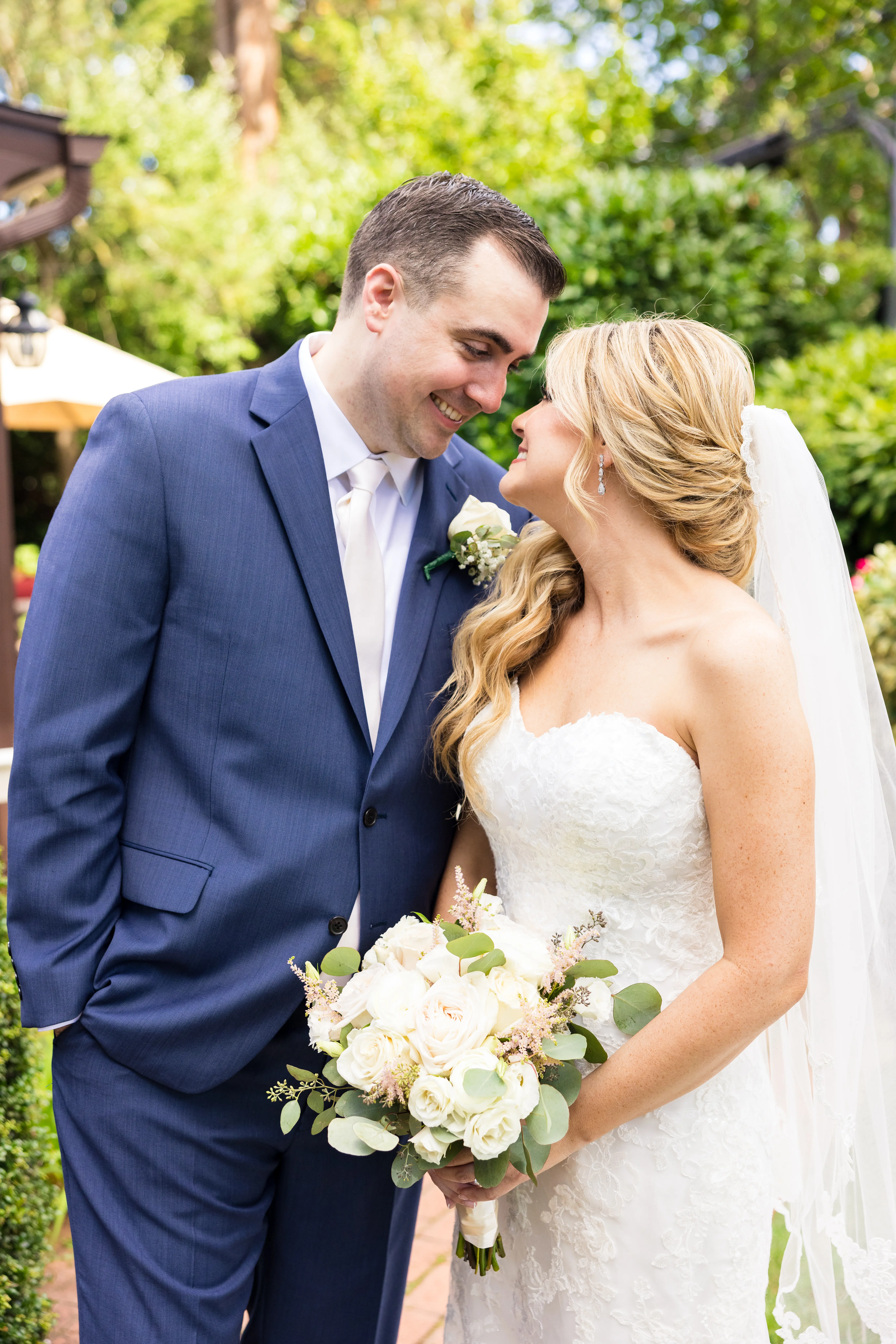 Bride Wearing 3-D Flower Fit-And-Flare Bridal Gown Named Ryker by Sottero and Midgley Bride and Groom Looking At Each Other