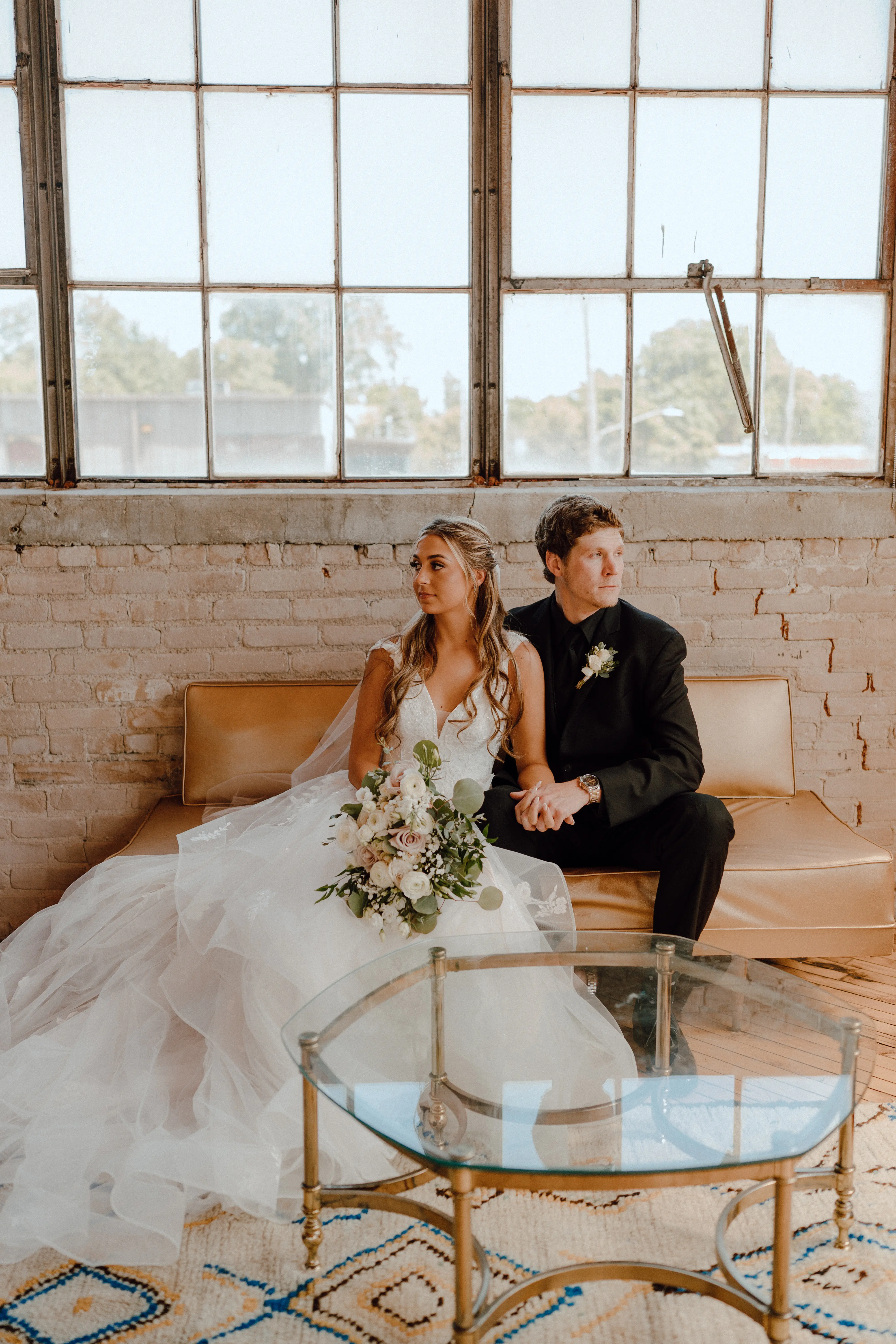 Bride in ruffle dress with illusion bodice called Lettie by Rebecca Ingram with groom