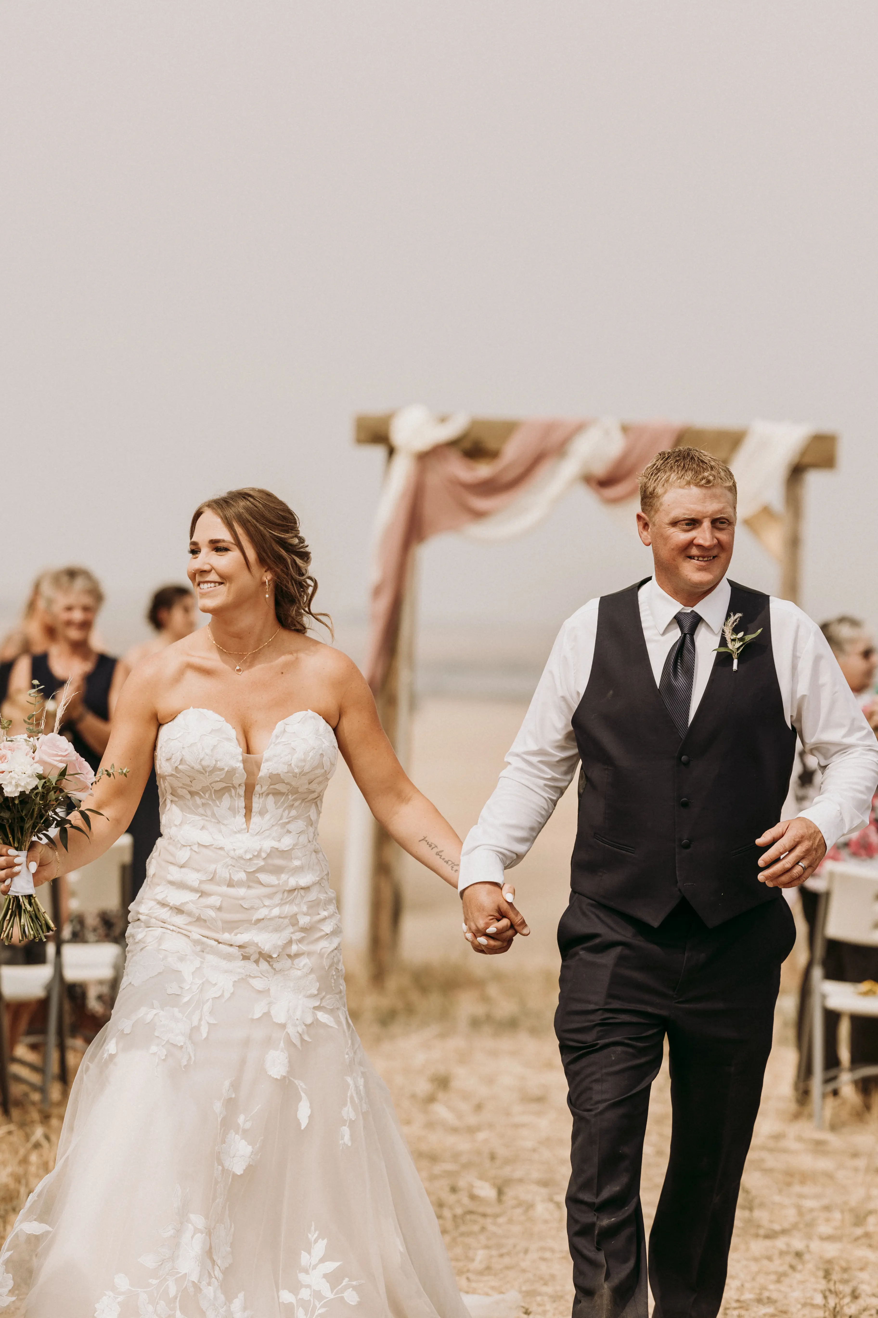 Bride with groom wearing strapless mermaid wedding dress