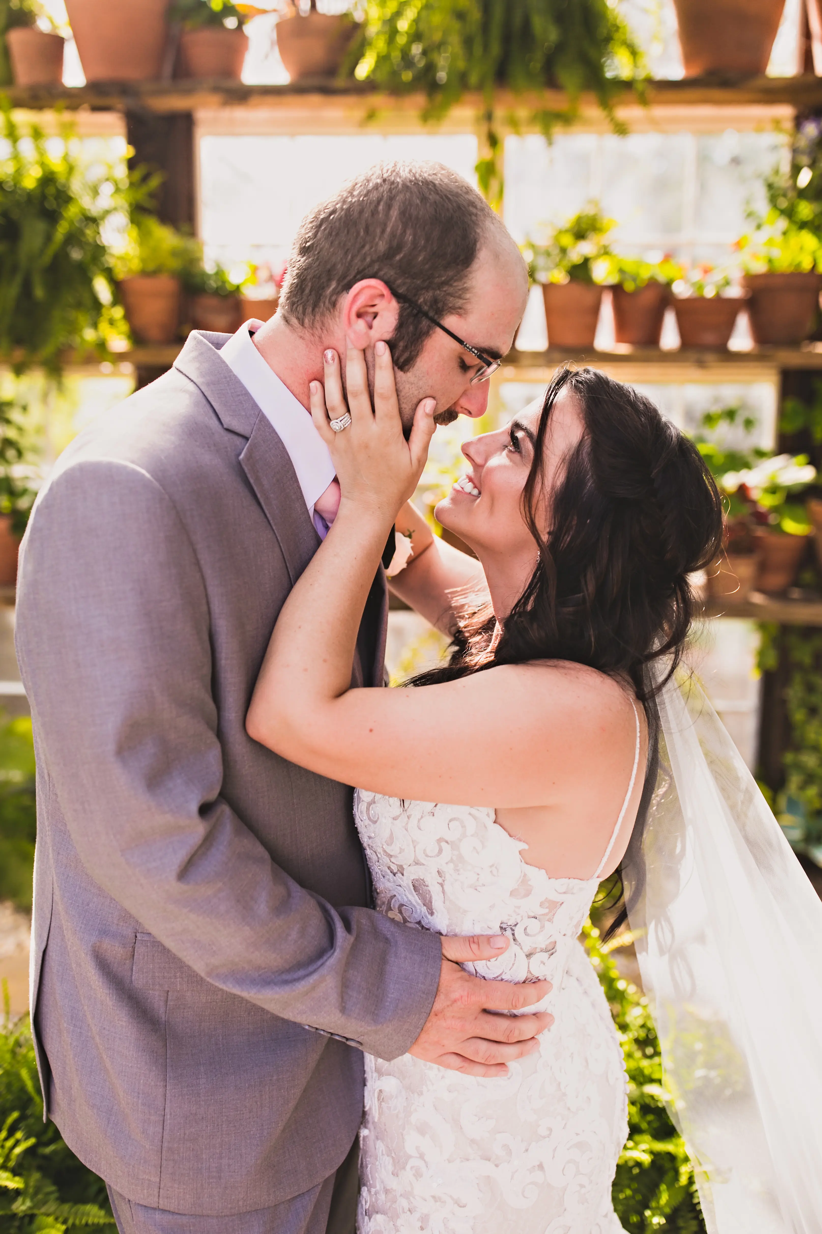 Groom Holding Bride in Shimmering Lace Motif Wedding Gown with Plunging Sweetheart Neckline Called Tuscany Lynette by Maggie Sottero