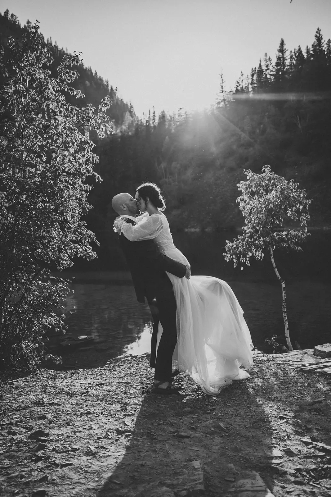 Groom Lifting Bride in Mountains Wearing Vintage Boho Wedding Gown Called Joanne by Rebecca Ingram.