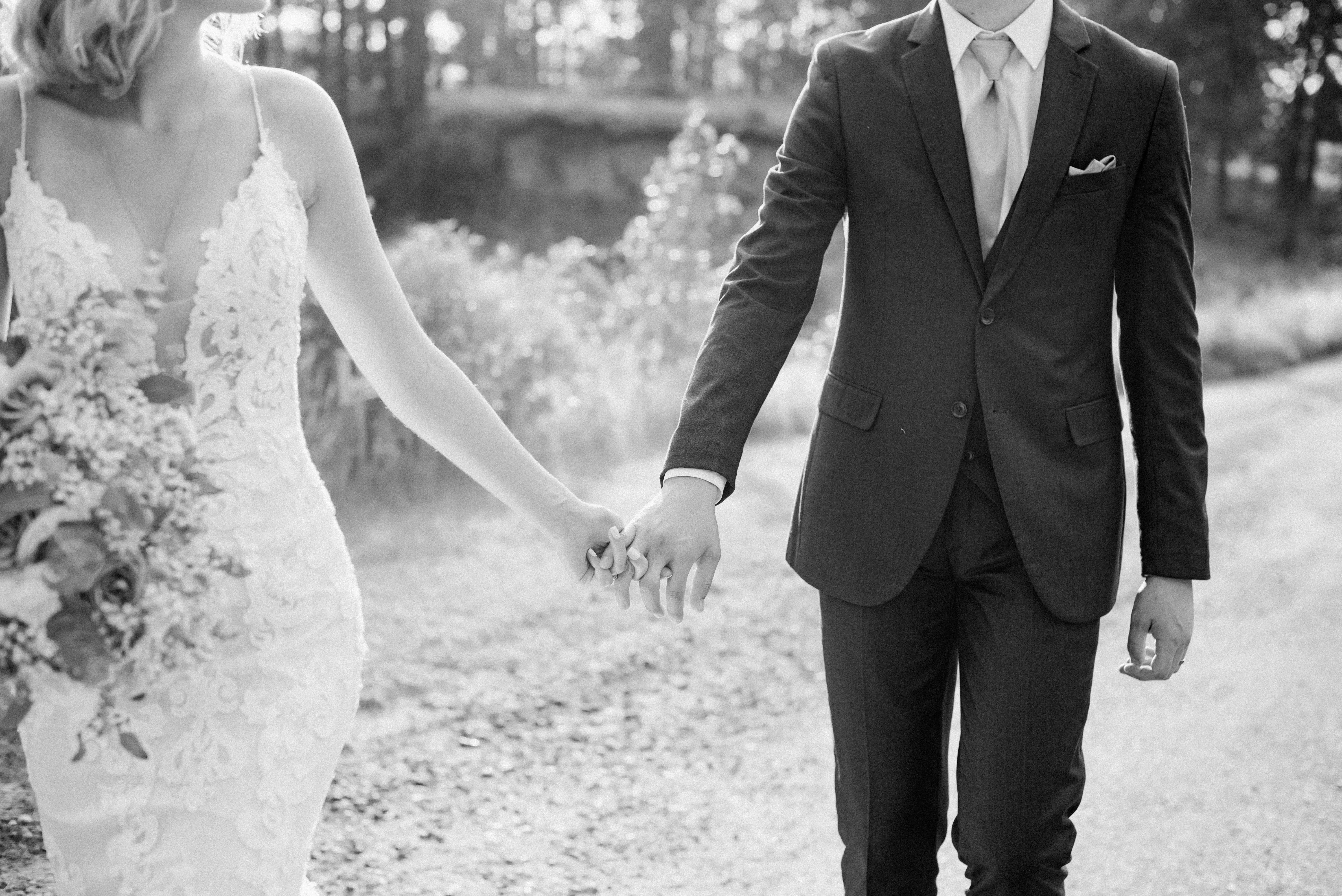 Bride with groom wearing lace sheath wedding dress