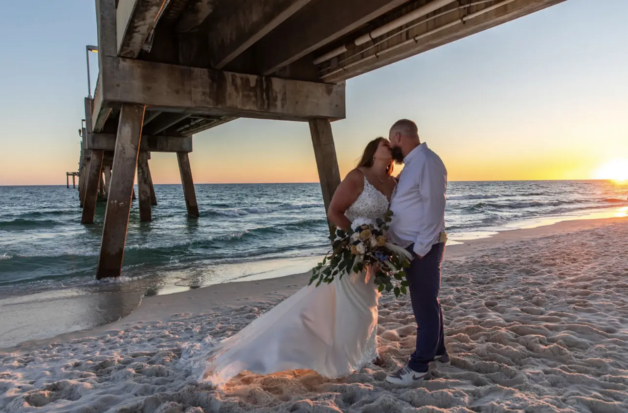 Bride wearing Johanna Lane wedding dress by Maggie Sottero kissing her husband