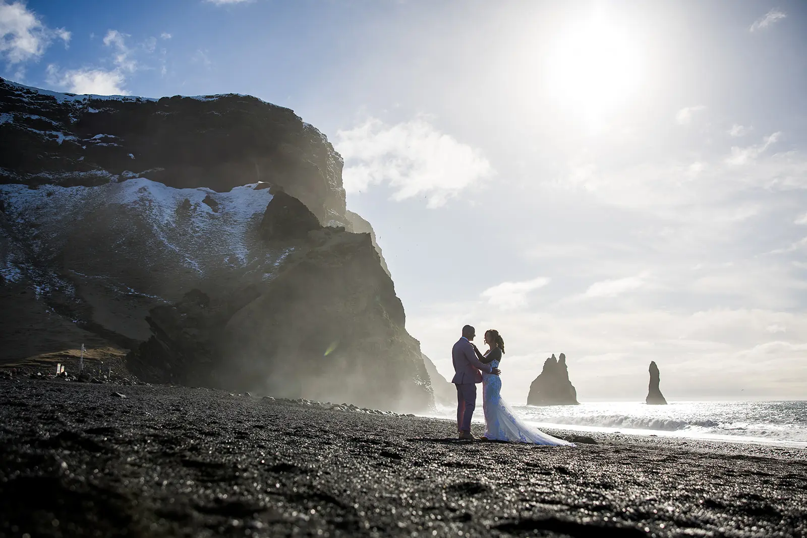 Bride wearing Tuscany Lynette by Maggie Sottero with her husband on the beach