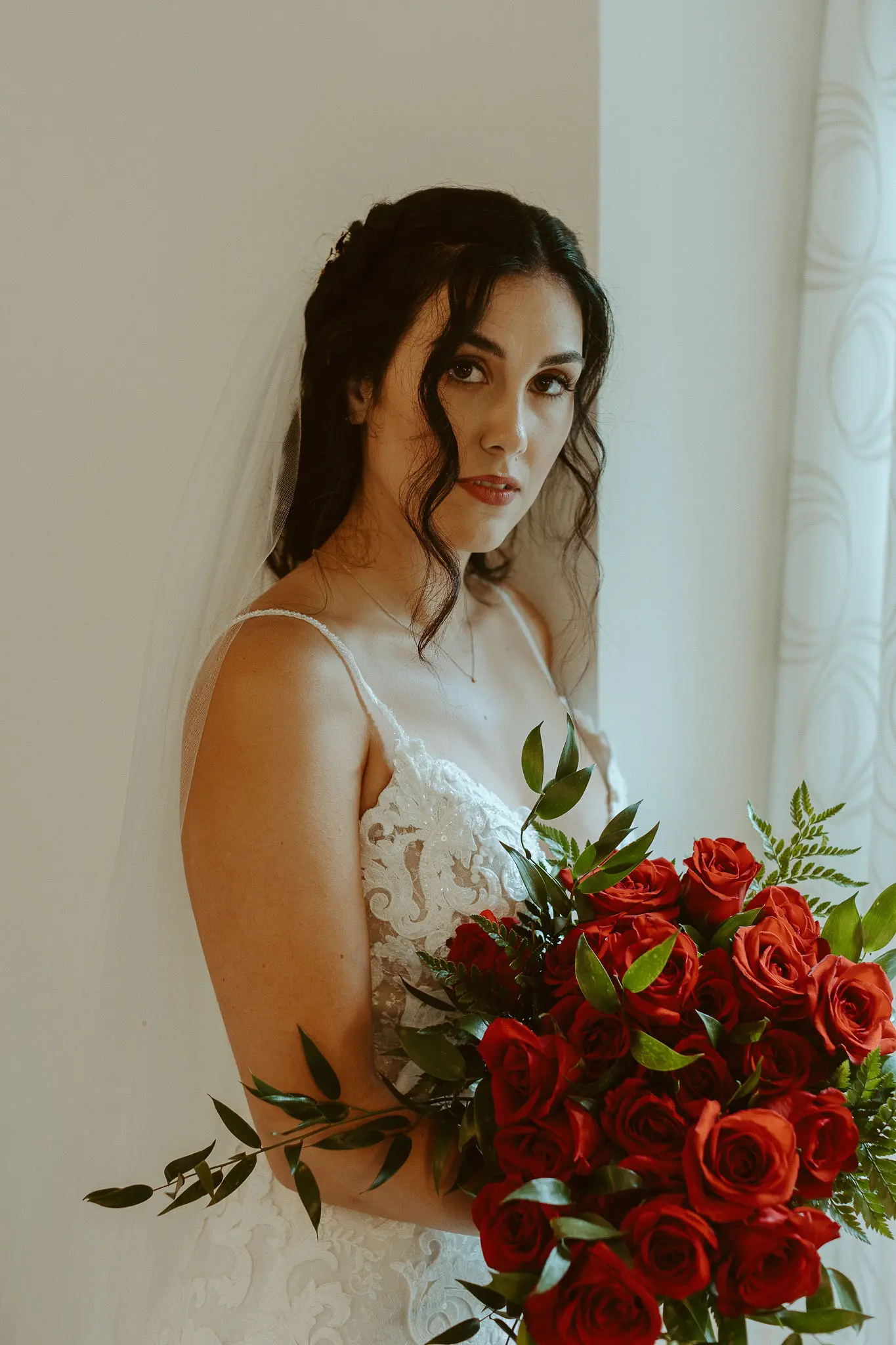 Bride wearing lace sheath wedding dress.