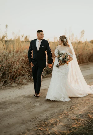 Groom Walking With Bride In Lacey Off The Shoulder Wedding Dress Named Fiona By Maggie Sottero