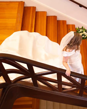 Bride Wearing Vintage Glamour Timeless Off-The-Shoulder Fit-And-Flare Wedding Dress Called Josie By Rebecca Ingram