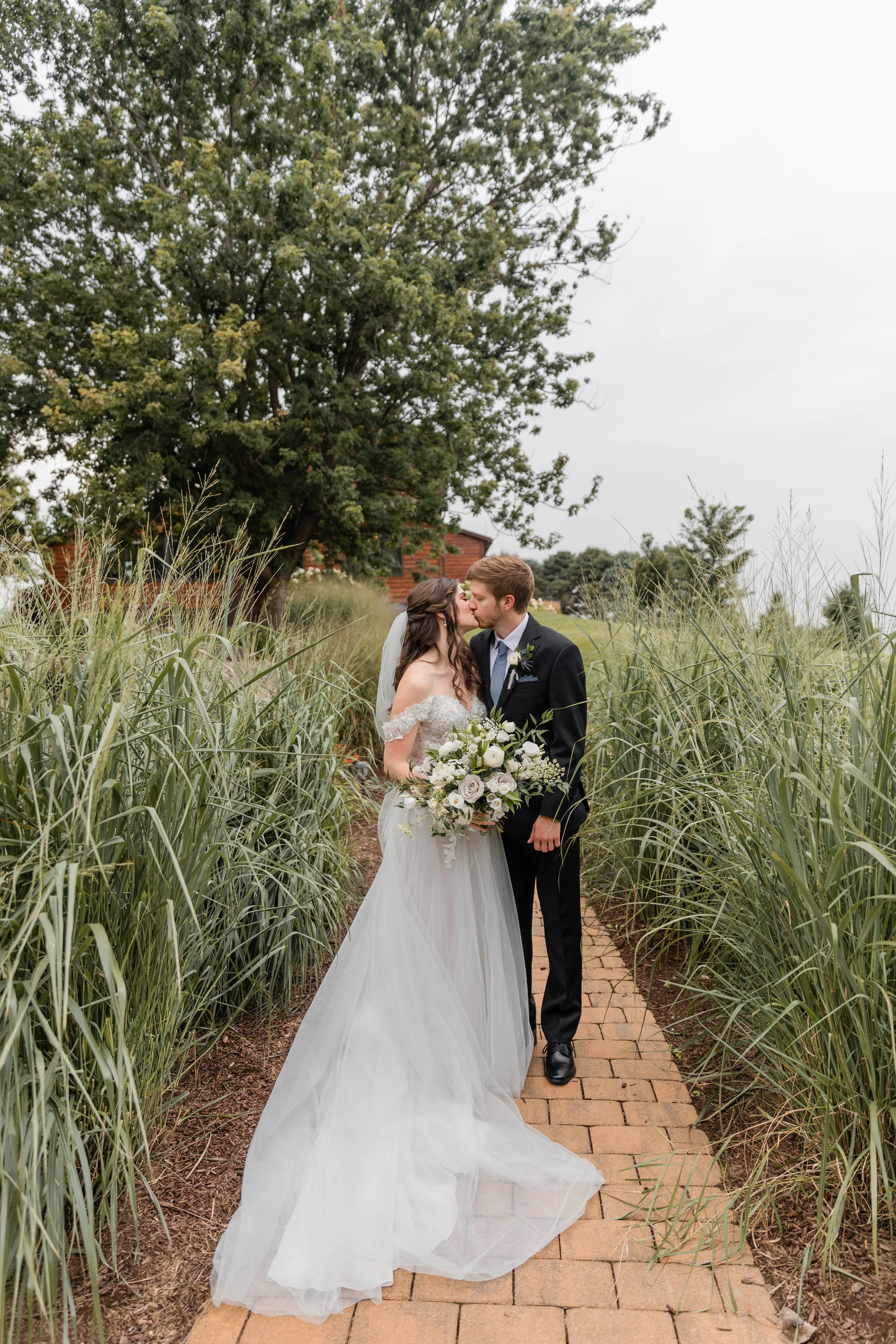 Groom With Bride Wearing A-Line Lace Wedding Dress With Customized Off The Shoulder Sleeves Stevie By Maggie Sottero