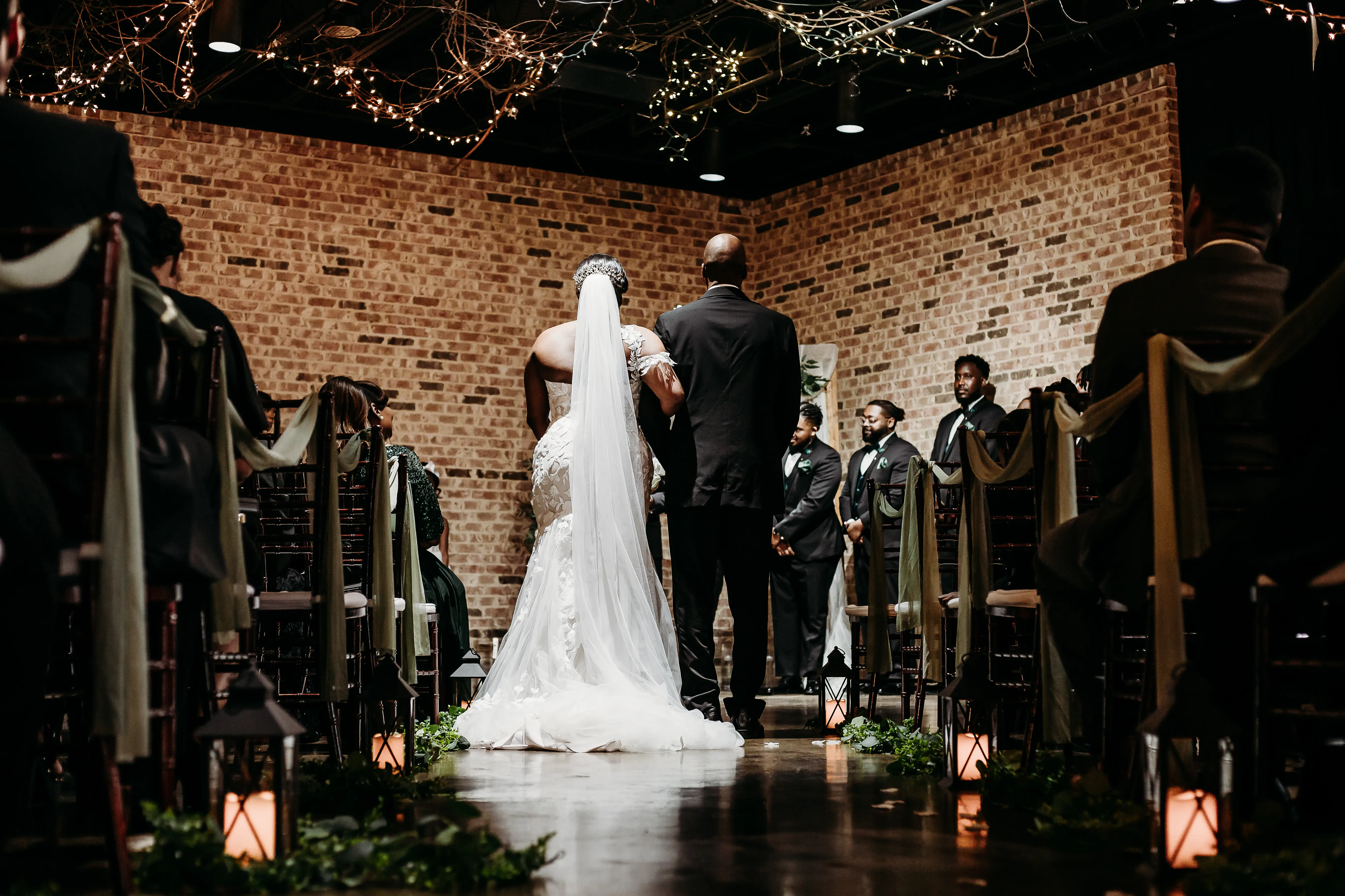 Bride wearing Hattie by Rebecca Ingram being walked down the aisle